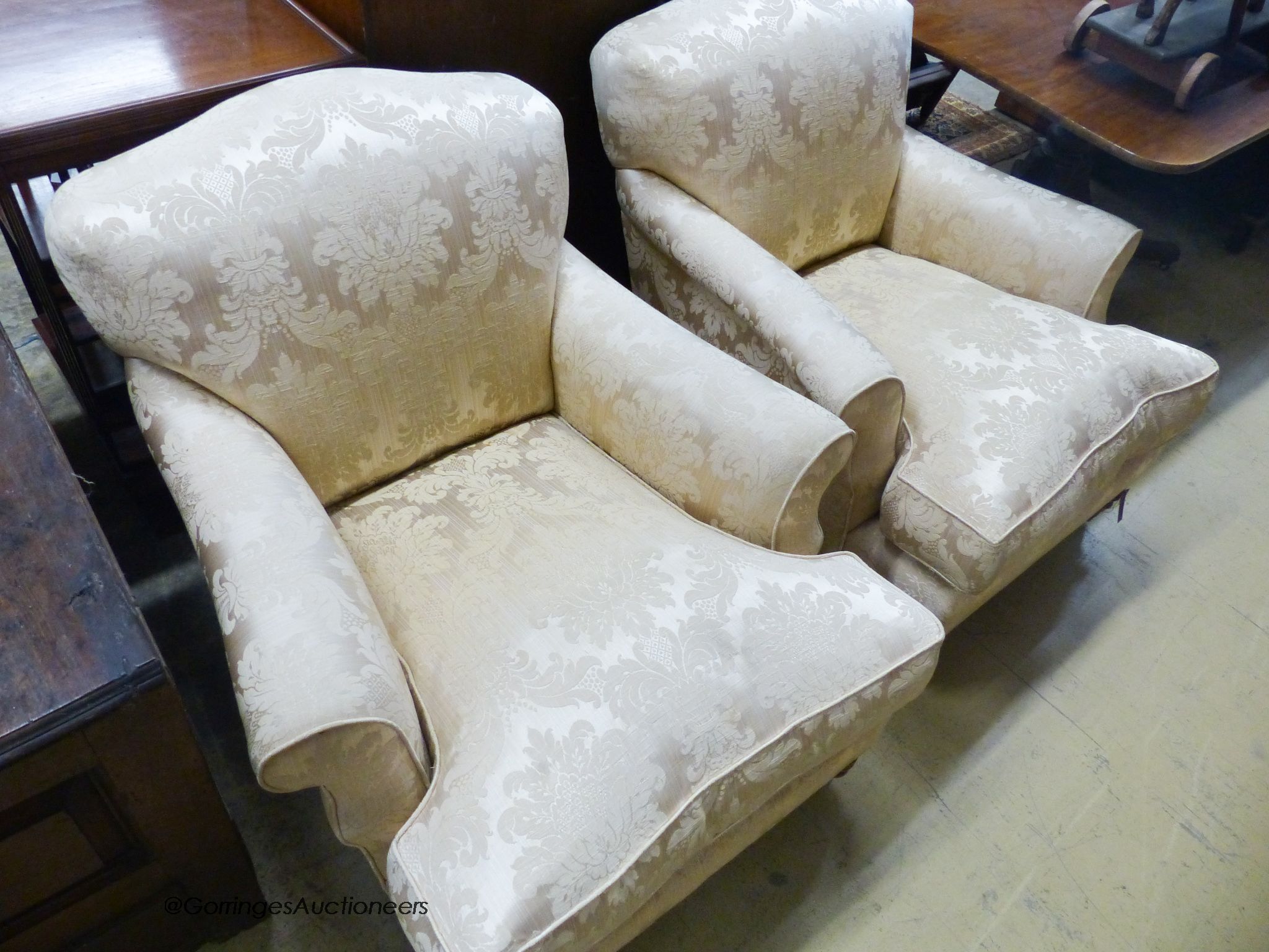 A pair of Howard style cream brocade upholstered lounge armchairs, width 85cm, depth 100cm, height 80cm